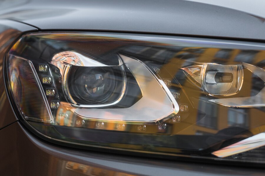 headlight-new-grey Man wiping car exterior after wash