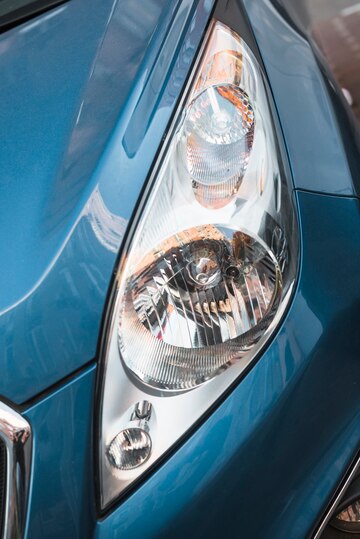 led-headlight-blue-car_23-2147962992 Car being detailed in professional setting