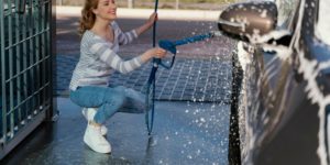 Woman preparing car for detailing at Freshest Auto Spa